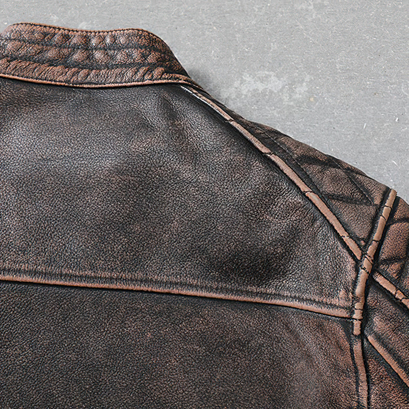 Close-up of the vintage brown leather motorcycle jacket showcasing the textured collar and unique stitching.