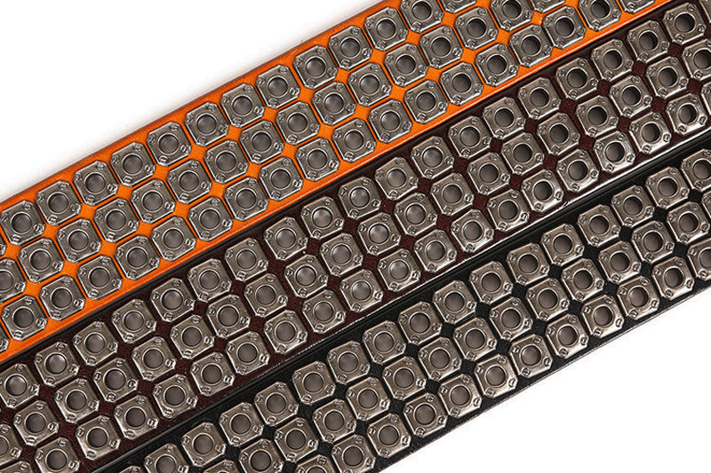 Rows of heavy metal cowboy belts showcasing rivet details in orange, black, and brown colors for a bold western style.