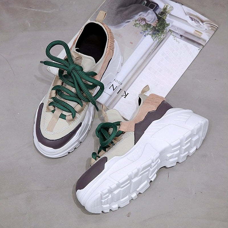 Stylish height increasing women's running shoes with green laces and a trendy design, perfect for everyday wear.