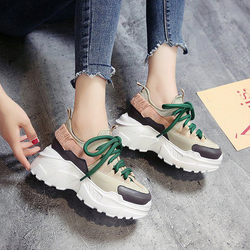 Stylish women's high platform sneakers with green laces and an original design, perfect for running and everyday wear.
