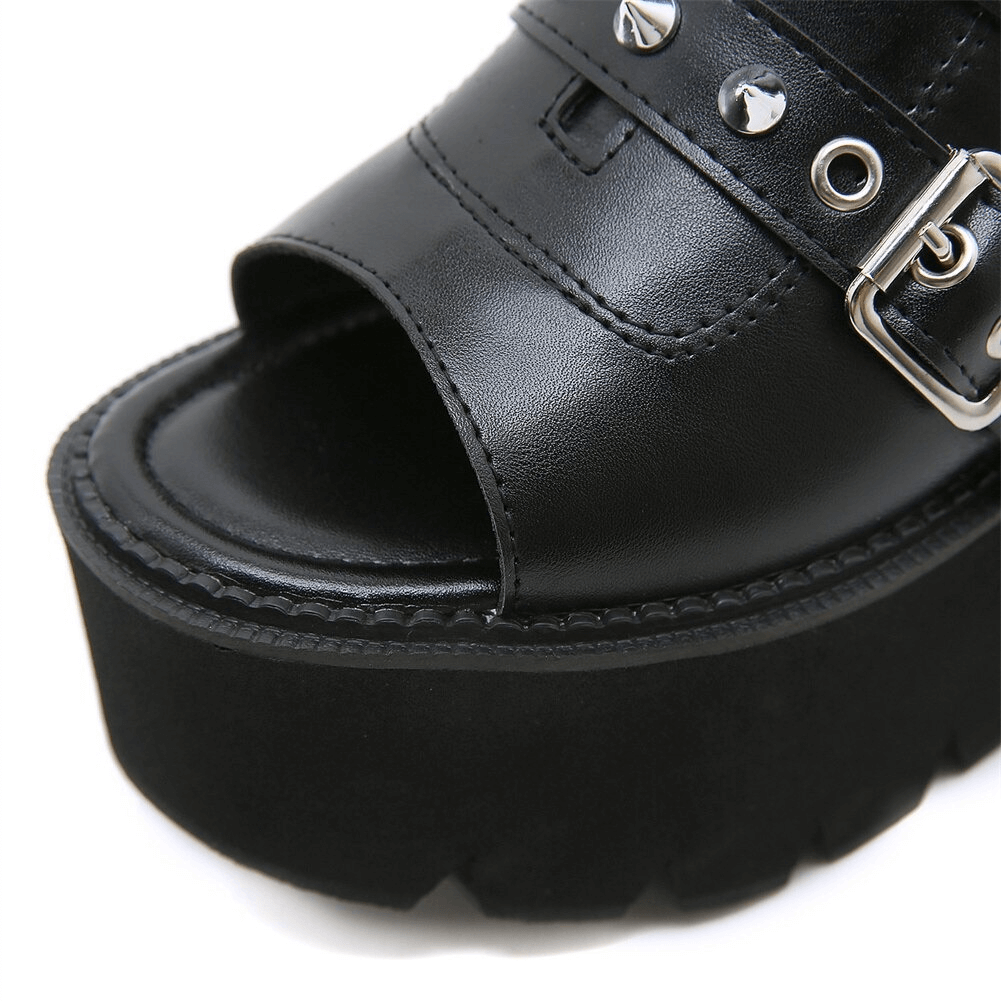 Close-up of black PU leather open toe platform sandals for women with buckles and spikes.