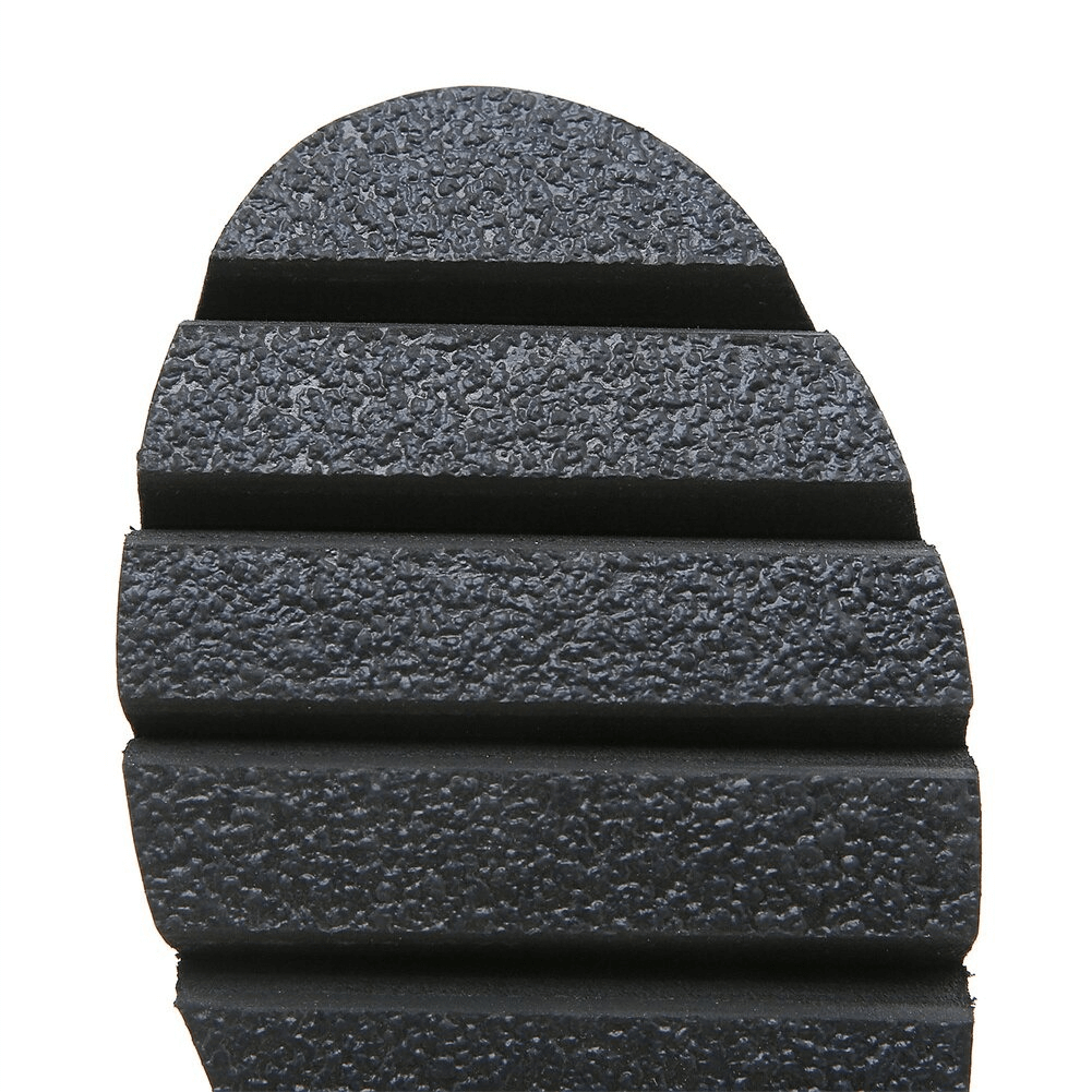 Close-up view of black PU leather sandal sole, showcasing textured platform design for stylish comfort.