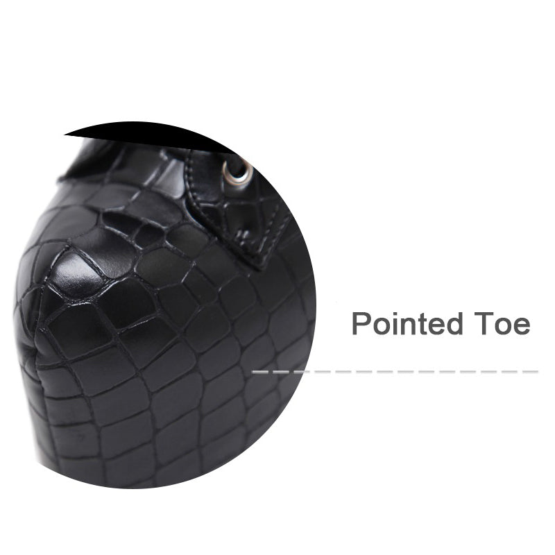 Close-up of pointed toe design on black crocodile pattern ankle boots, showcasing unique style and elegance.