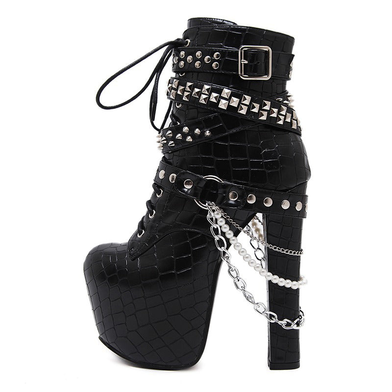 Stylish women's ankle platform boots with chains and rivets, patent leather finish, Gothic-inspired high heels.