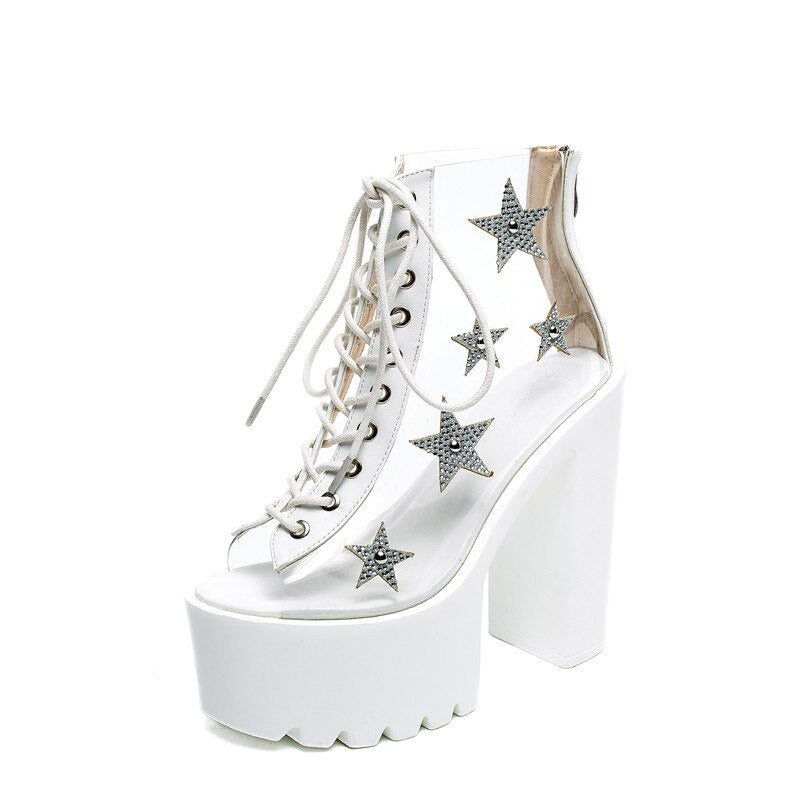 Punk style women sandals with lace-up design, PVC panels, and star crystals on a tall platform heel.