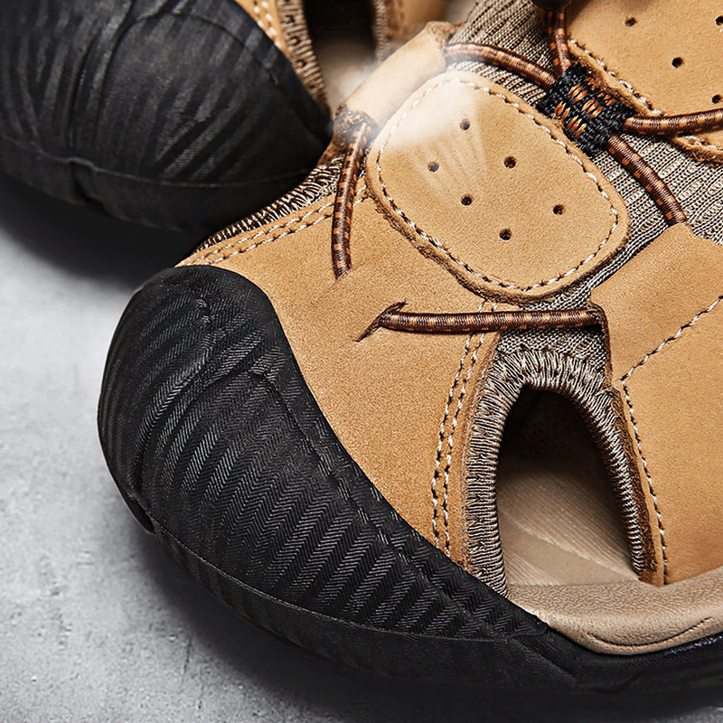Close-up of split leather summer sandals for men featuring breathable design and rubber outsole.