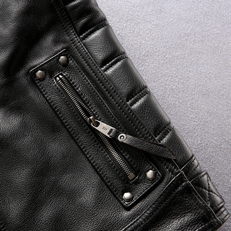 Close-up of a black genuine leather motorcycle vest featuring a detailed zipper pocket.