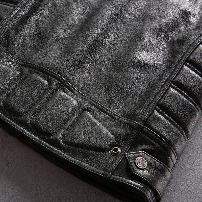 Close-up of a stylish black genuine leather motorcycle biker vest with textured details and zippers.