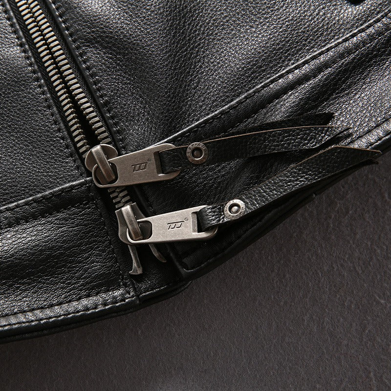 Close-up of zippers on a black genuine leather motorcycle biker vest showcasing stylish details.