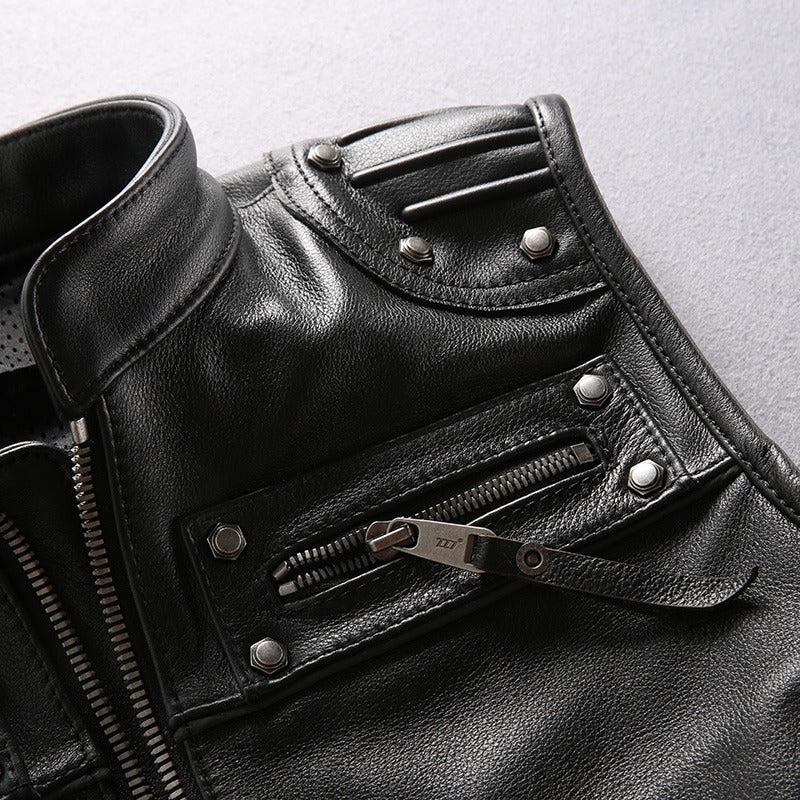 Close-up of men's genuine leather motorcycle biker vest featuring zippers and metal detailing.
