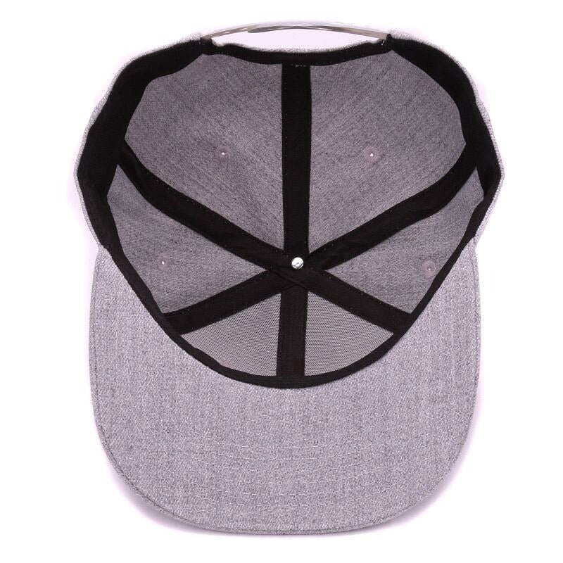 Inside view of a grey wool cap with black lining and ventilation holes, perfect for style and comfort.