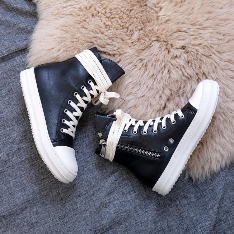 Stylish black high top sneakers with white laces on a cozy fur background, perfect for retro rock lovers.