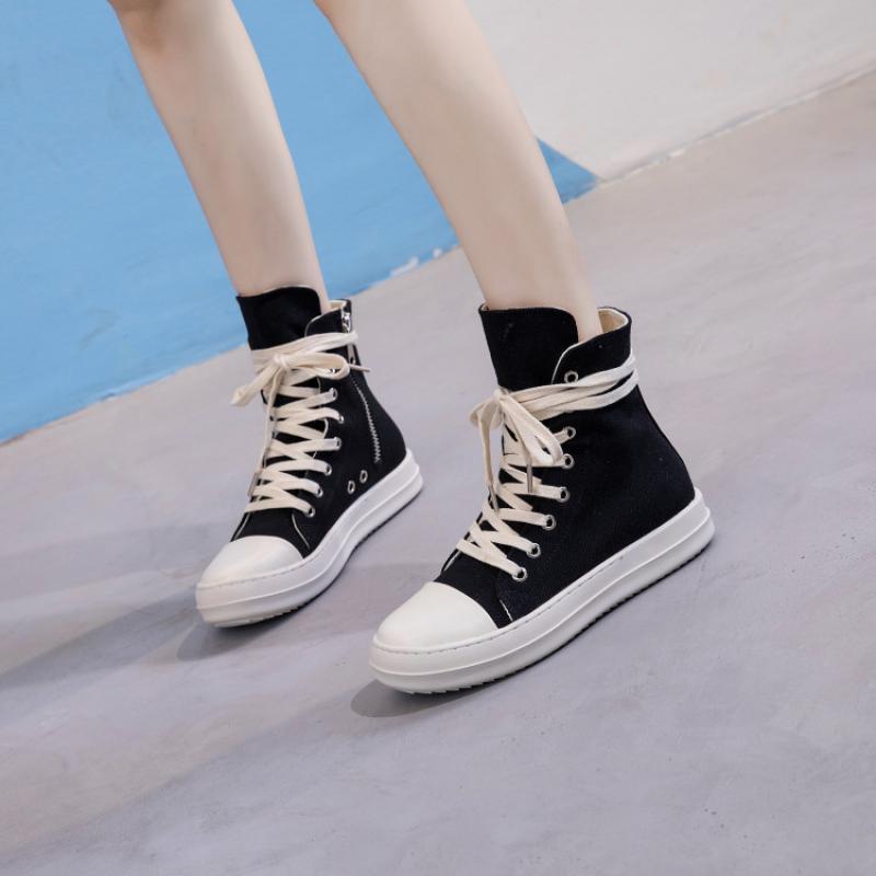 Female retro black high top sneakers with white laces, perfect for rock lovers and alternative fashion.