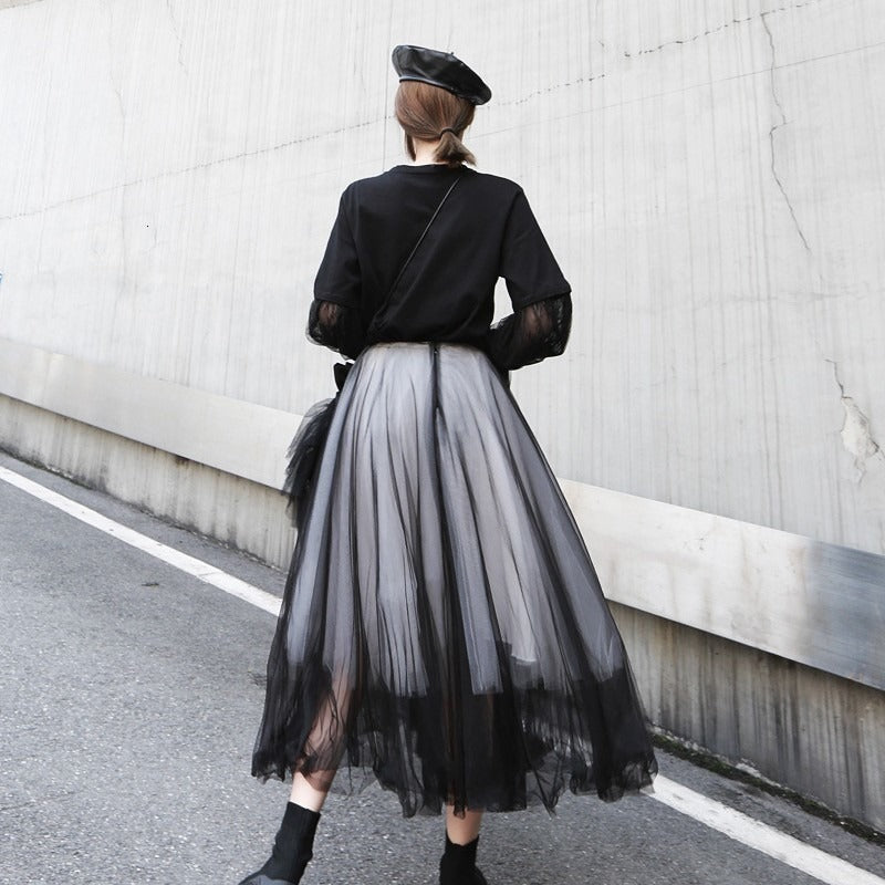 Back view of a woman in a high waist black 5-layer mesh half-body skirt, showcasing gothic fashion style.