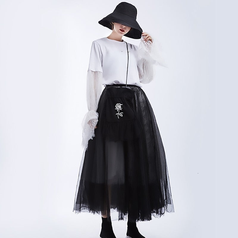 High waist black mesh skirt with rose embroidery, paired with a chic white blouse and stylish hat, perfect for gothic fashion.