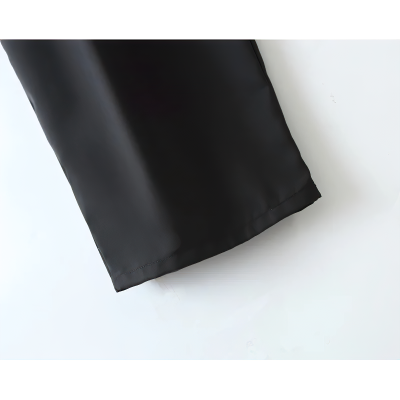 Close-up of high waist black pleated women's pants, showcasing sleek fabric and sturdy hem design.