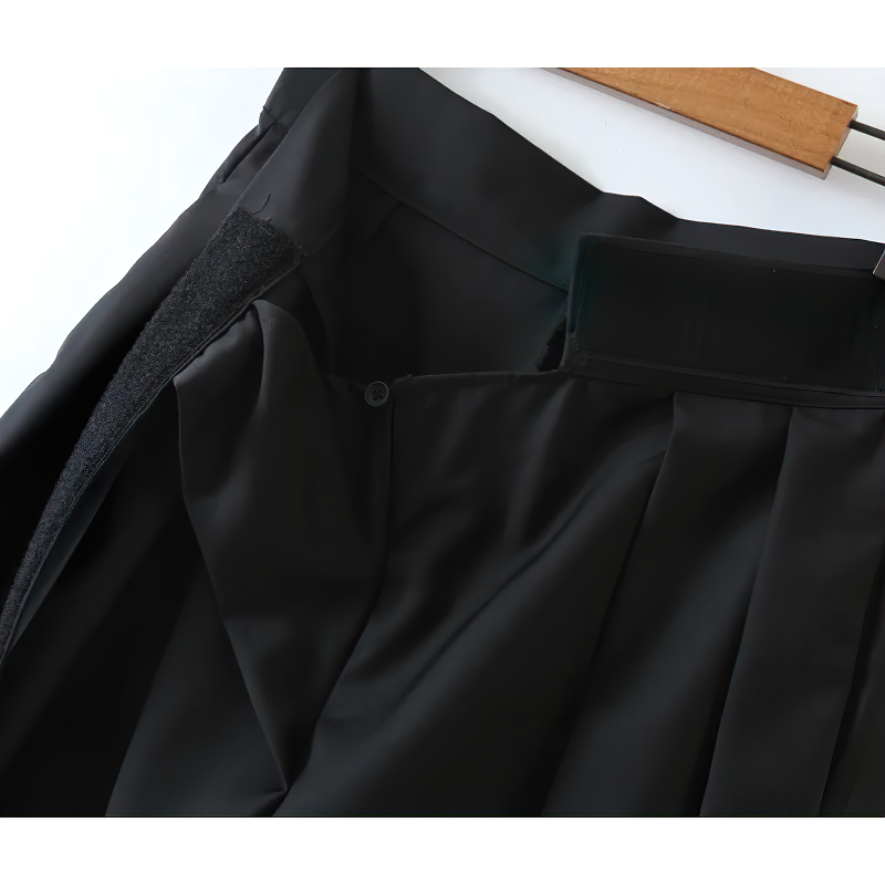 Close-up of high waist black pleated women's pants showcasing the waistband and pocket details.