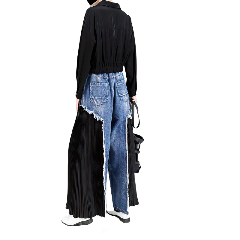 Stylish woman wearing high waist blue denim trousers with pleated side panels, perfect for a fashionable look.