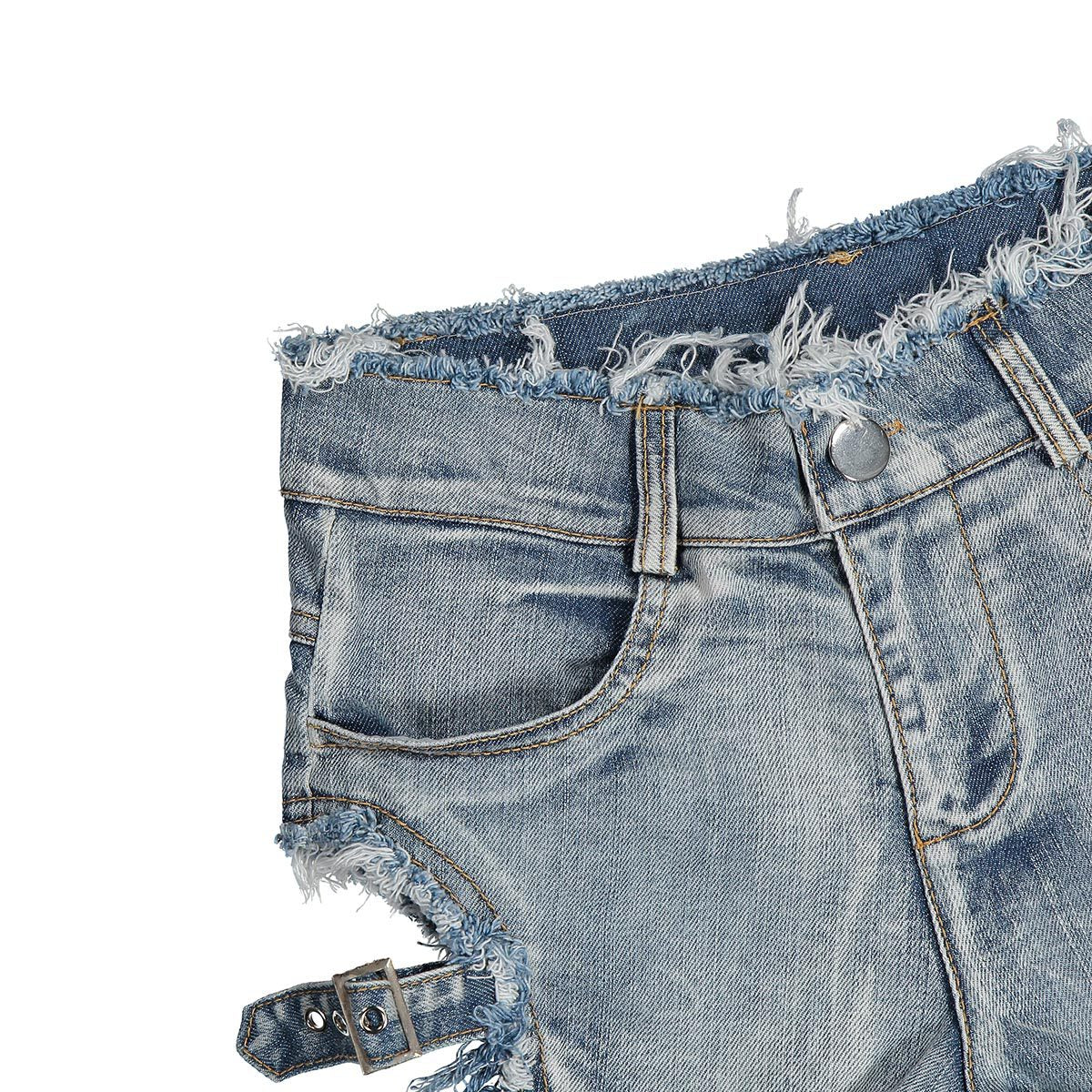 Close-up of high waist denim shorts with distressed edges and decorative side buckles for a rocker chic style.