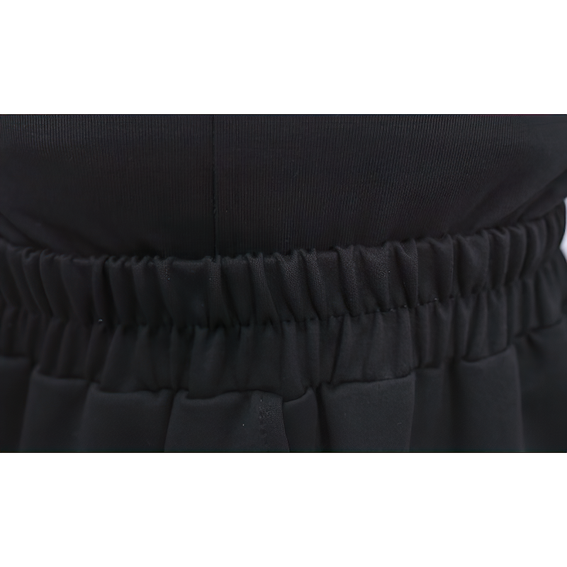 Close-up of a high waist elastic band on stylish black women's pants, showcasing comfort and fashion.