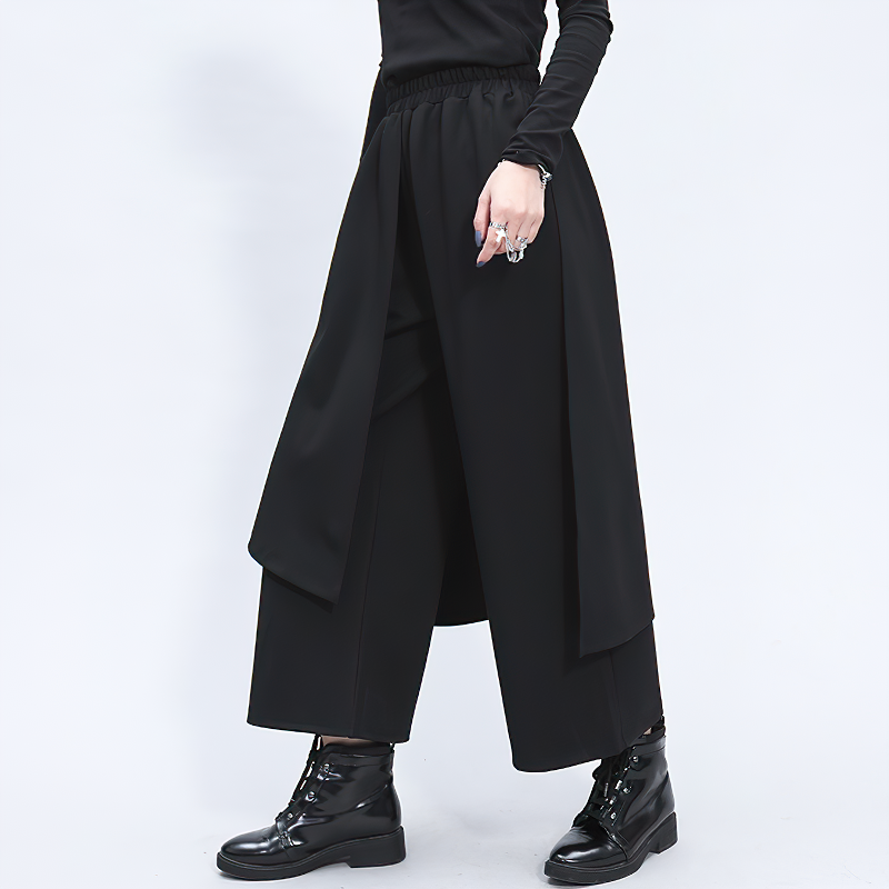 High waist black elastic women's pants with pockets, stylish split joint design for goth and alternative fashion.