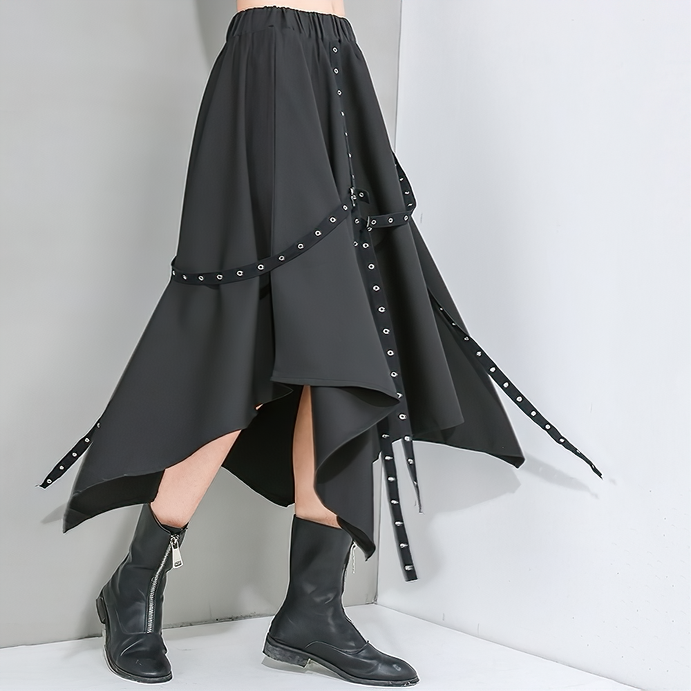 High waist asymmetrical black skirt with straps and rivets, perfect for alternative and gothic fashion enthusiasts.