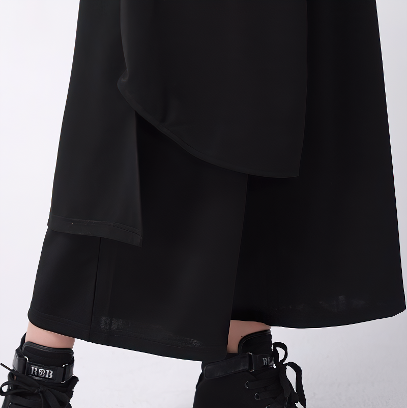 Close-up of black high waist fashion women's pants featuring an elastic waist and stylish ankle-length design.