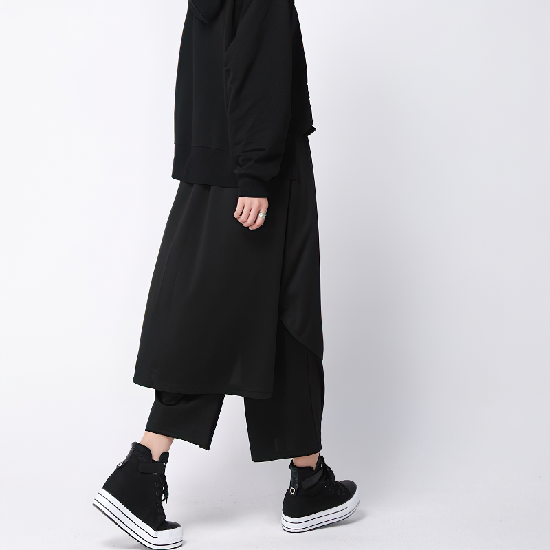 Stylish woman in loose-fitting black high waist pants and hoodie, showcasing comfortable and trendy ankle-length fashion.
