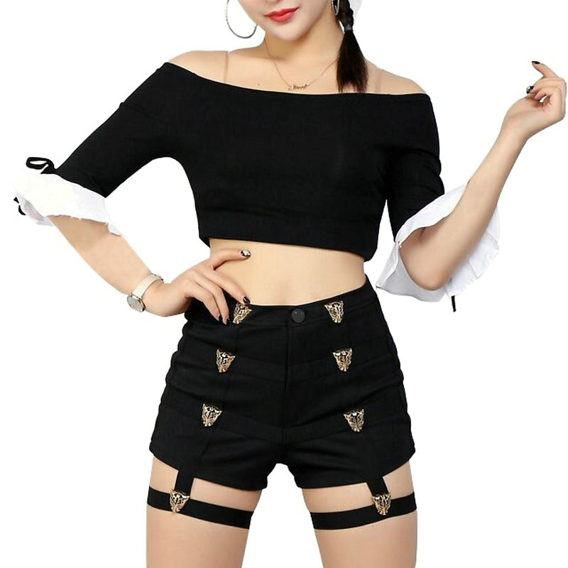 Stylish women in black off-shoulder crop top and high waist short shorts with metal leopard buttons for rave outfits.
