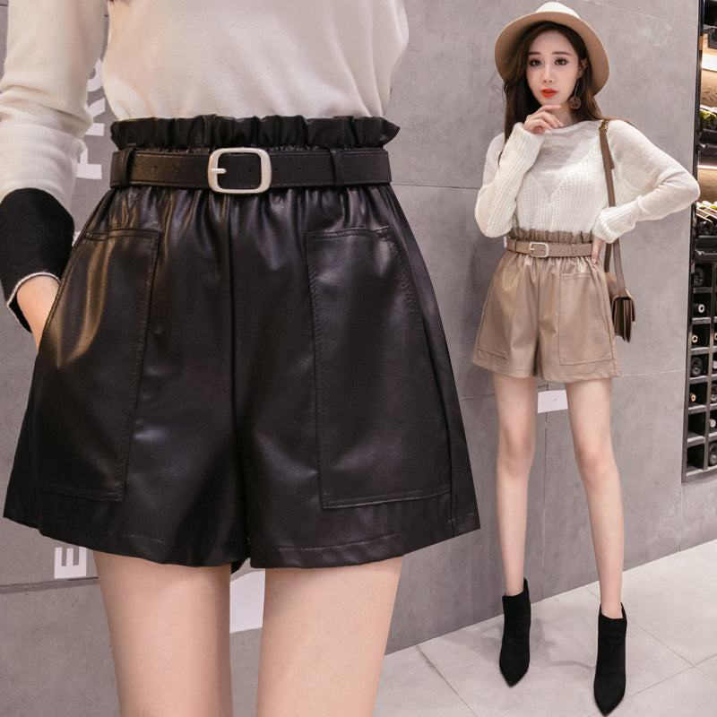 High waist faux leather shorts with solid pockets and belt, featuring stylish wide-legged design for women's trendy outfits.