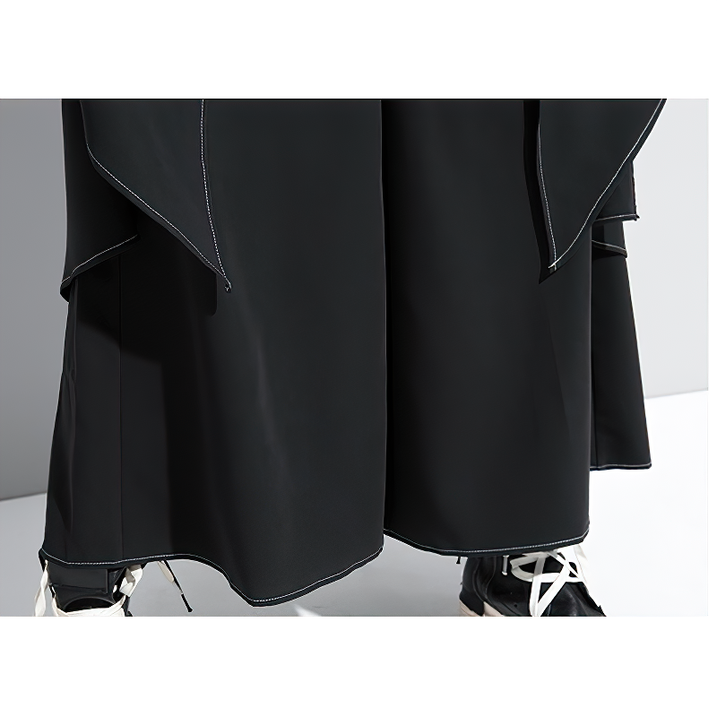 Close-up of stylish high waist wide leg black women's trousers with a loose fit and elegant draping.