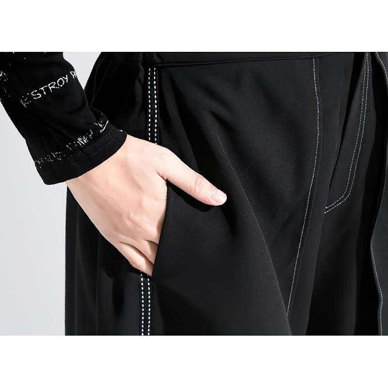 Close-up of black women's trousers showing elastic waist and pocket detail, stylish and comfortable design.