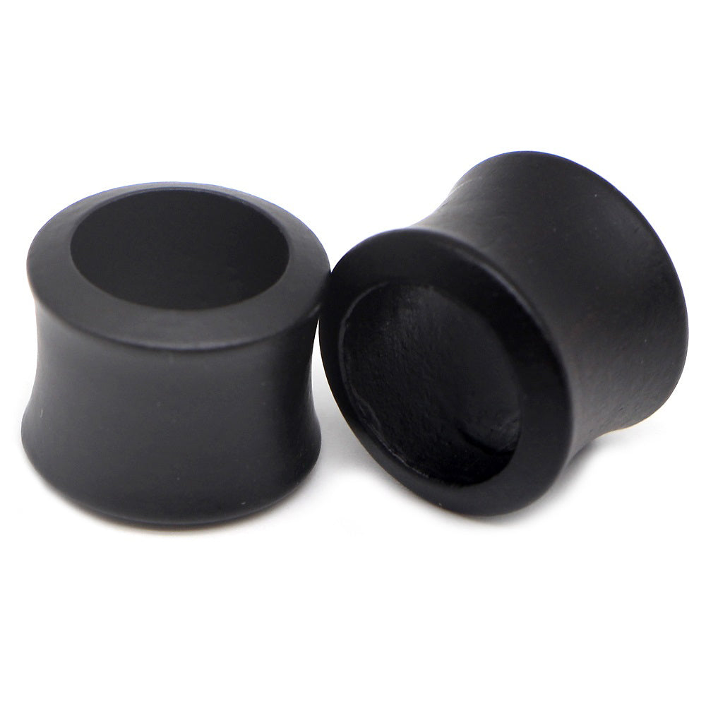 Hollow black wooden plugs and tunnels for body piercing earrings, perfect for a punk rock look and comfort.