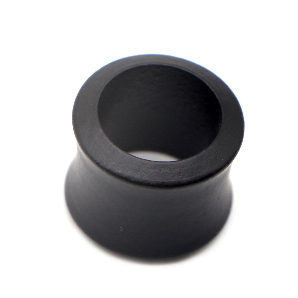 Hollow black wooden tunnel earring stretcher for body piercing, perfect for a punk rock look.