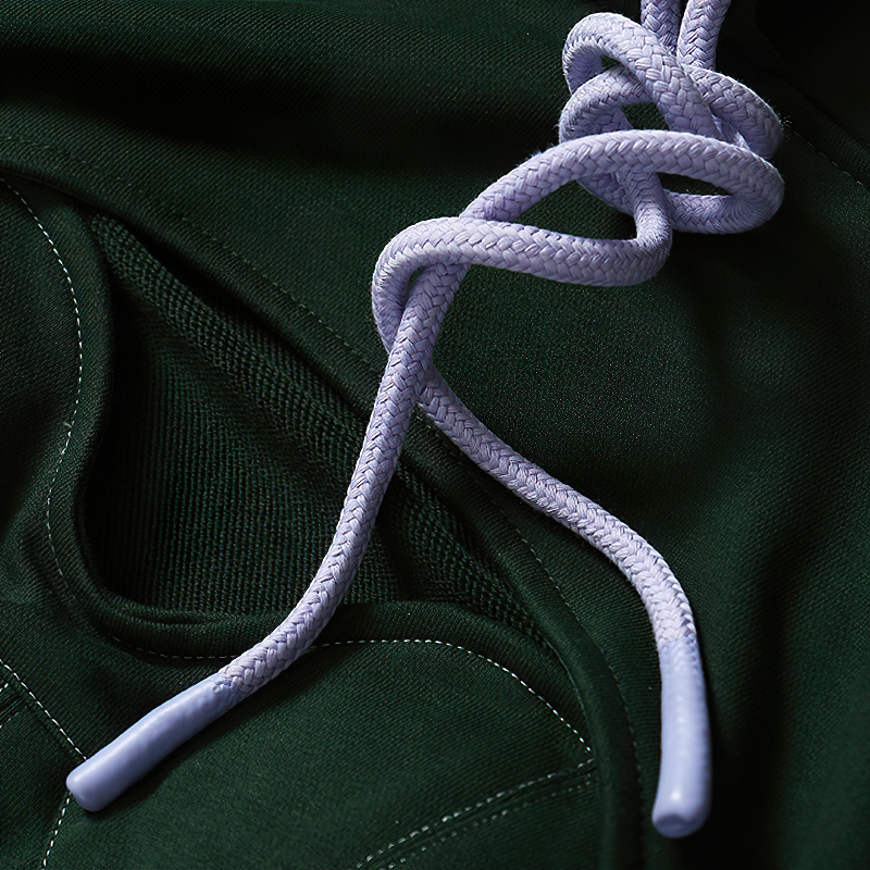 Close-up of stylish purple lace on a green hooded long sleeve top for women, perfect for alternative streetwear.