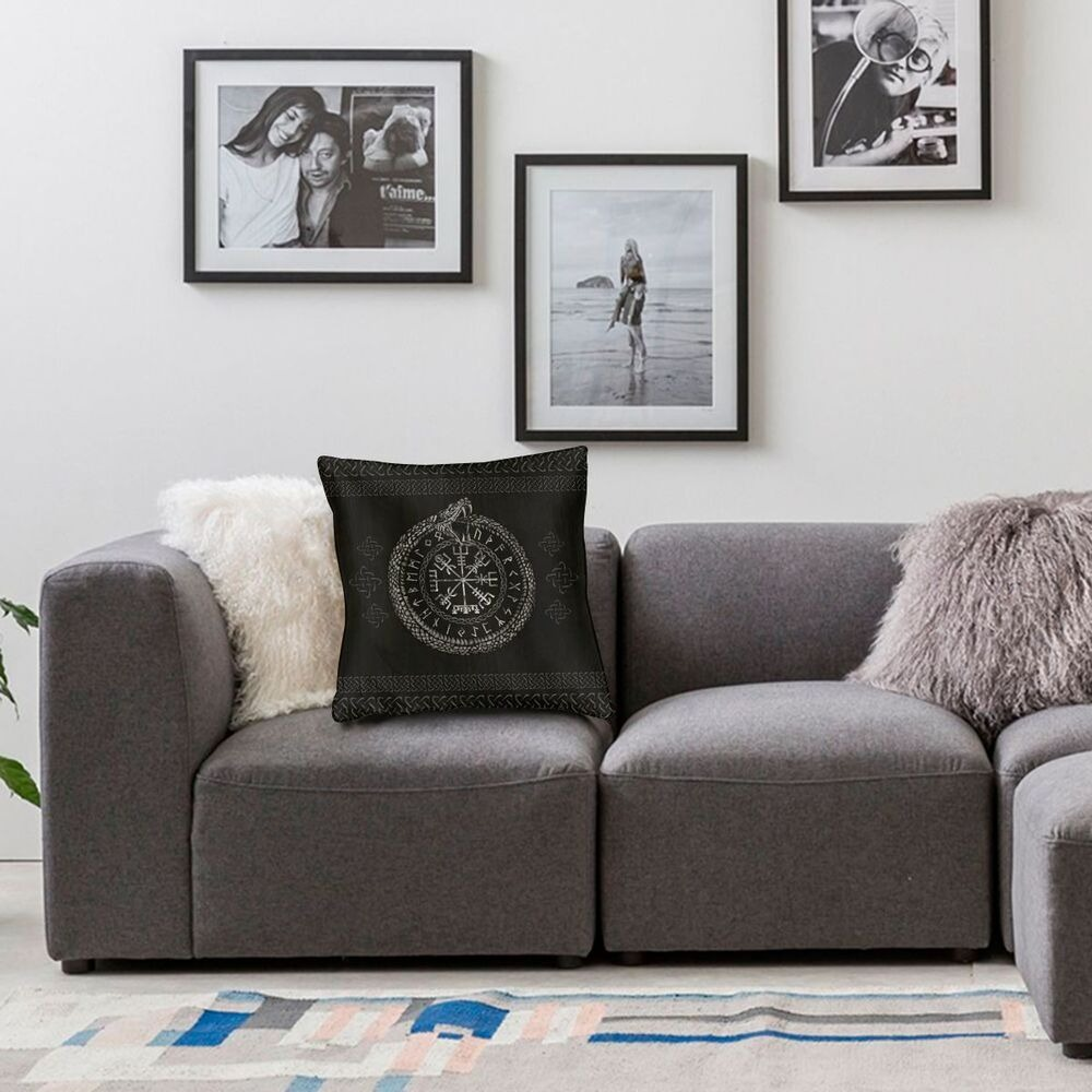 Viking Helm of Awe decorative pillow on a cozy gray couch with stylish wall art surrounding it.