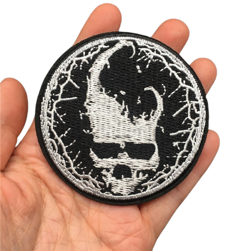 Unisex horned devil skull embroidery patch in hand, perfect for alternative fashion accessories.