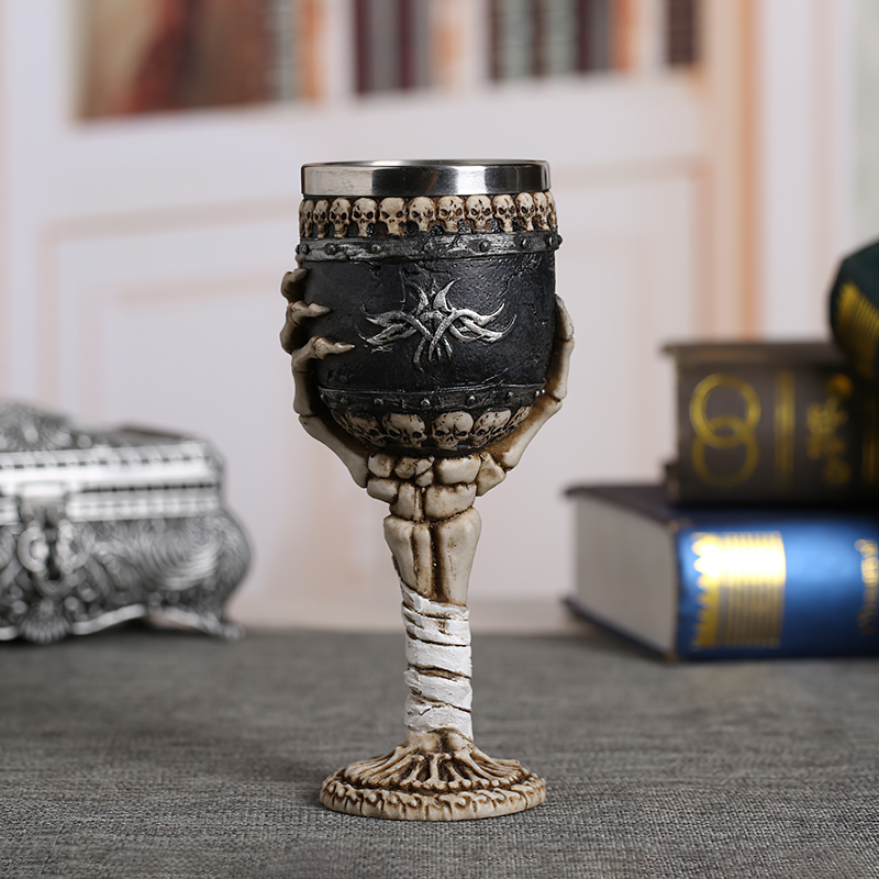 Horrible Death Claw wine glass with skulls and a skeletal arm for vintage gothic decor.