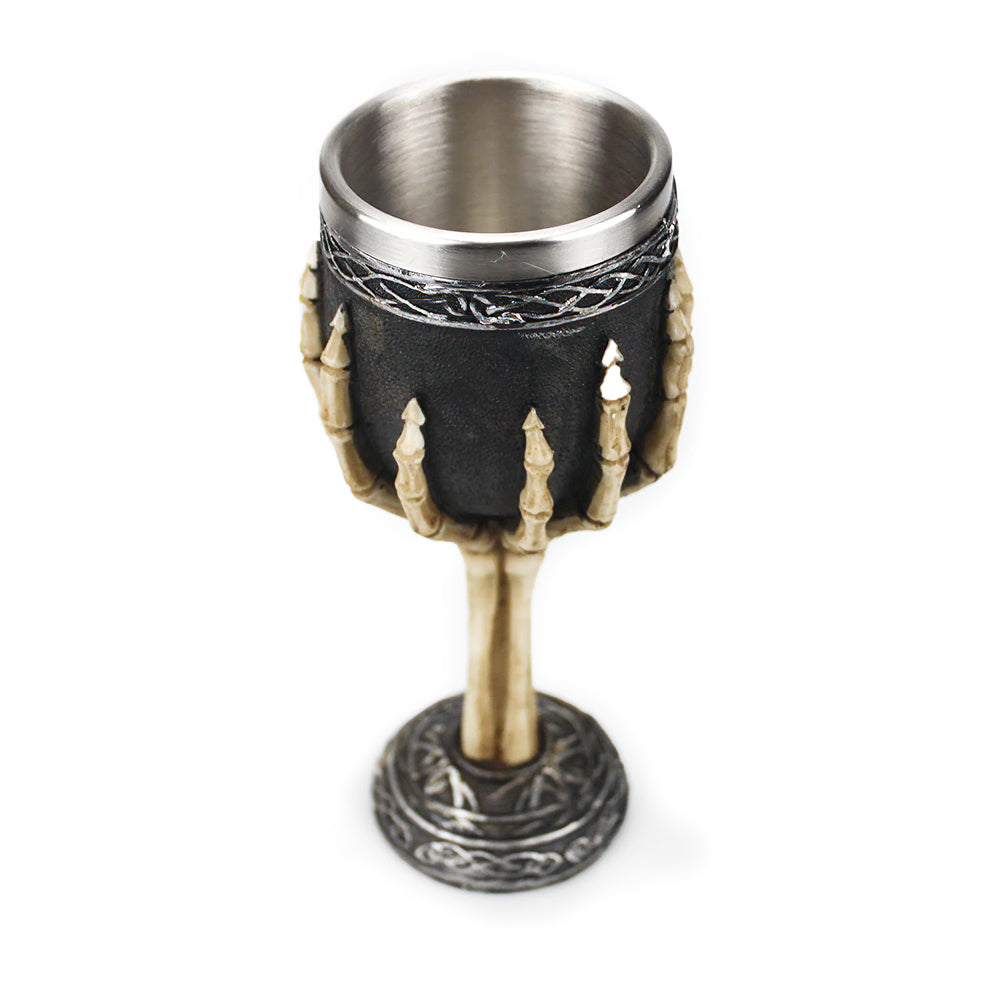 Gothic vintage wine glass featuring a bone hand design and stainless steel interior, perfect for decor and drinking.