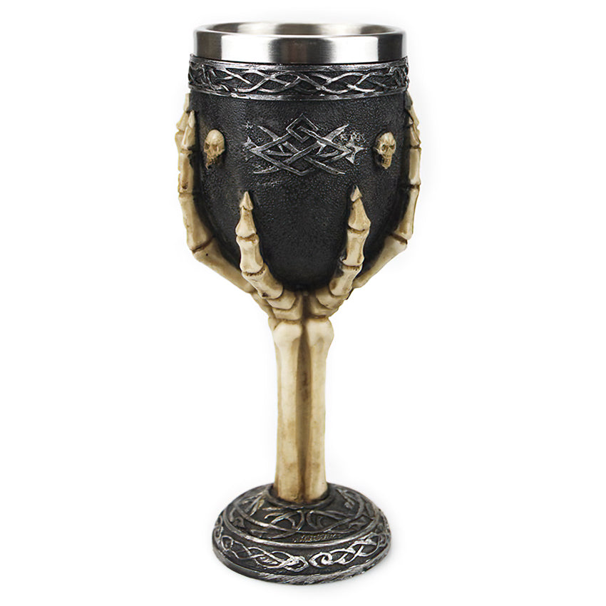 Vintage Gothic-style wine glass featuring a skeletal hand and skulls, perfect for dark-themed decor and wine lovers.
