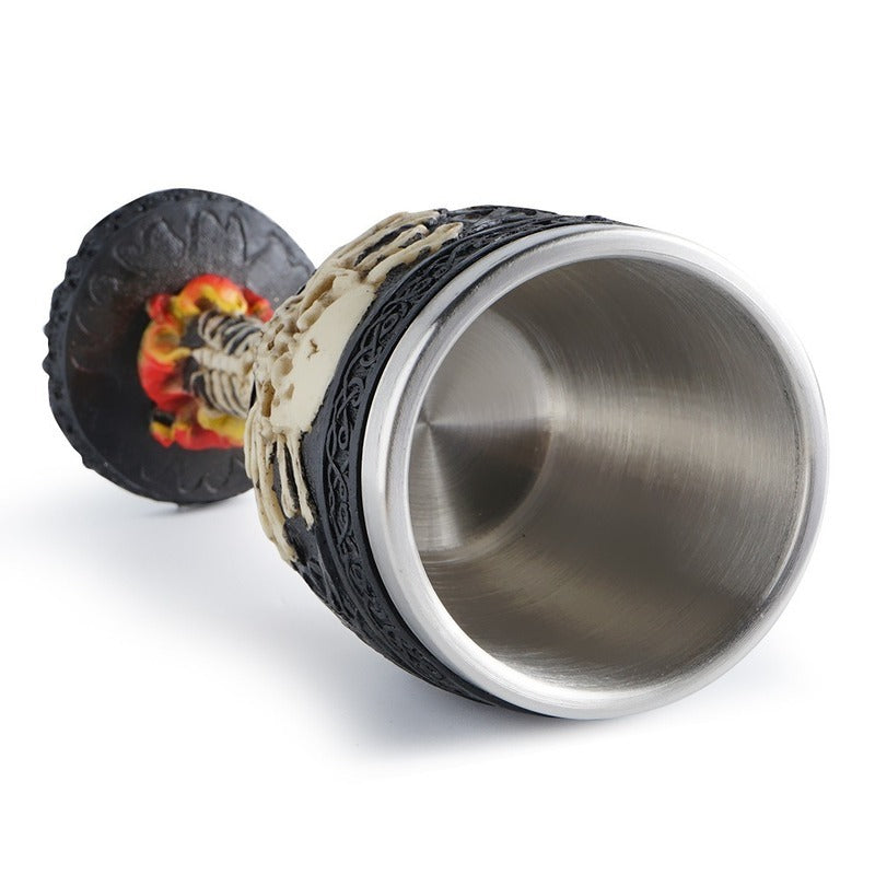 Vintage skull wine glass made of stainless steel with a Gothic design and fiery decorations.