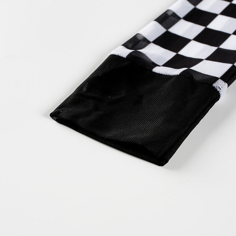 Close-up of the sleeve hem of a women's long sleeve plaid mesh top in black and white checkerboard pattern.