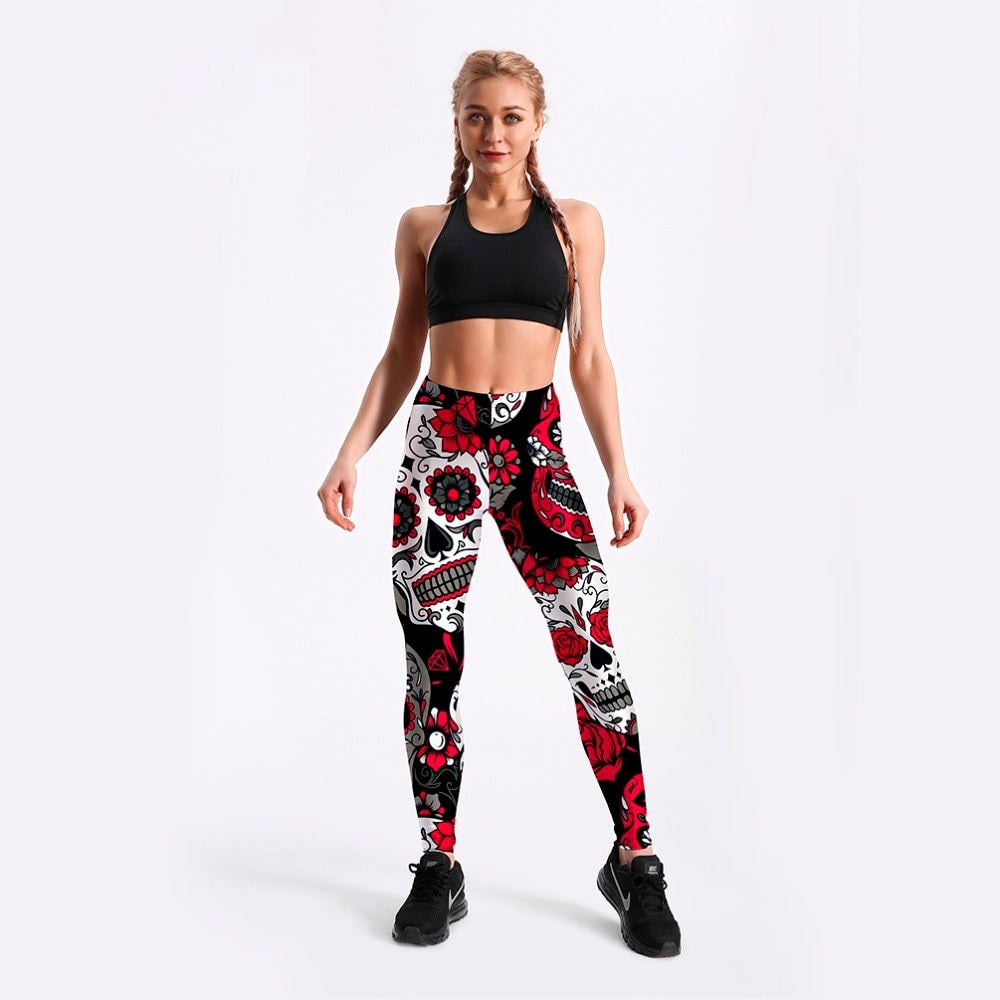 Stylish woman in skull and flower printed leggings, perfect for workouts and edgy outfits.