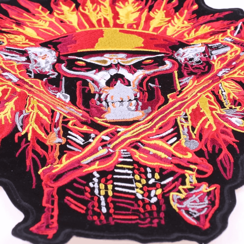 Vibrant Indian skull and tomahawks iron-on patch with fiery headdress, perfect for biker jackets and clothes.