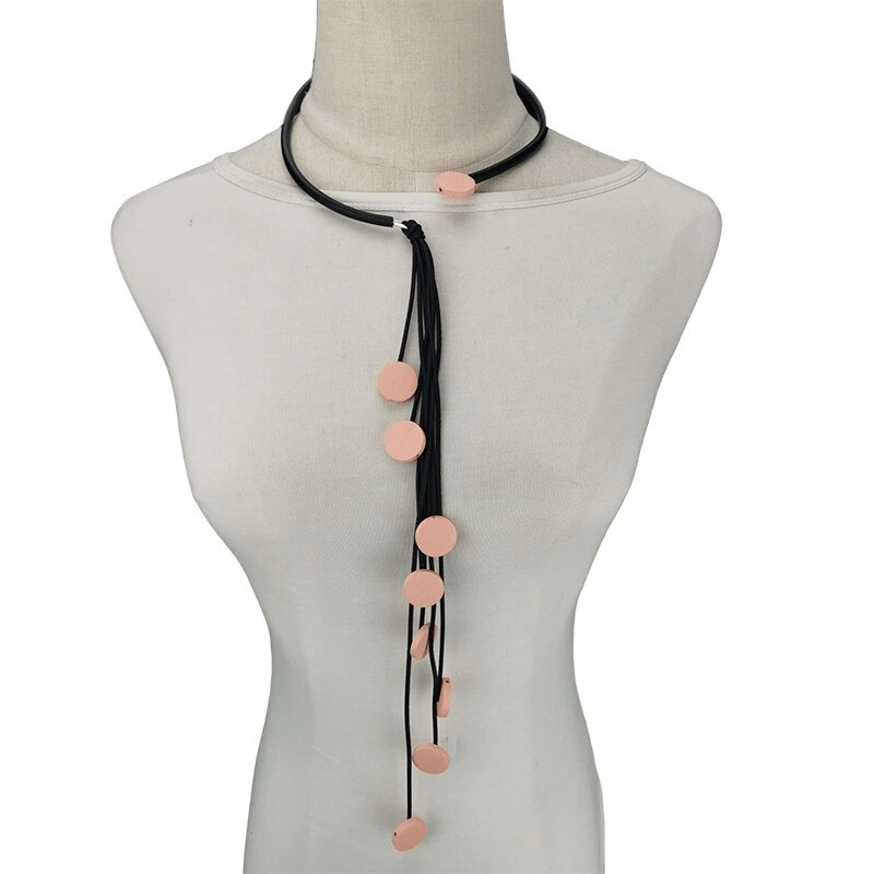 Handmade long rubber necklace with tassels and pink accents, a stylish accessory for women.