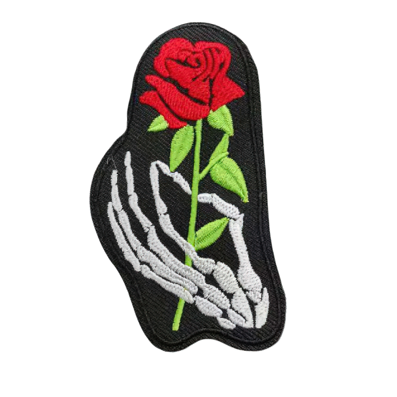 Gothic iron-on patch featuring a skeleton hand holding a red rose, perfect for styling clothing.