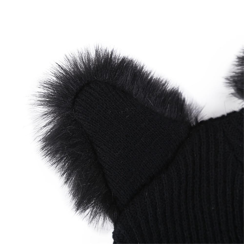 Close-up of fluffy black cat ears on a knitted beanie hat for women in cute alternative fashion.
