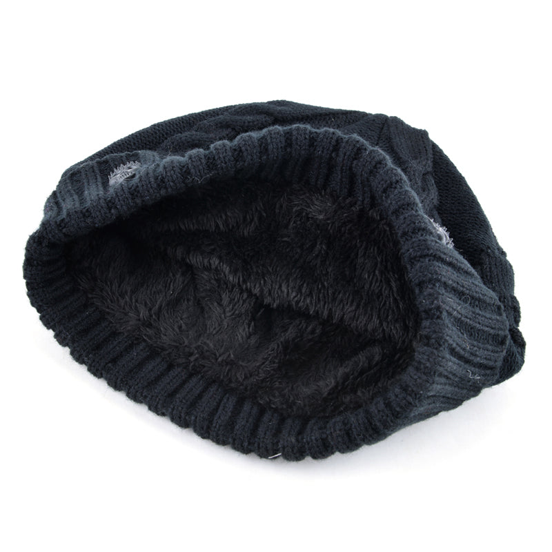Inside view of a cozy black knitted wool beanie with a soft lining, perfect for winter street fashion.