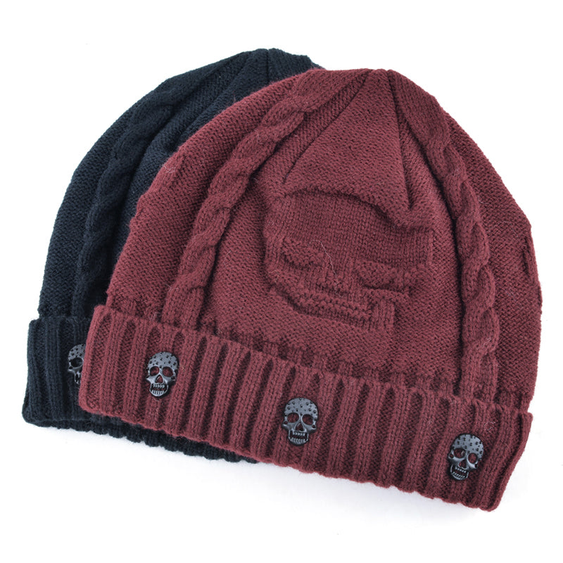 Knitted wool beanie hats in black and burgundy with unique skull patterns and decor for men’s alternative winter fashion.