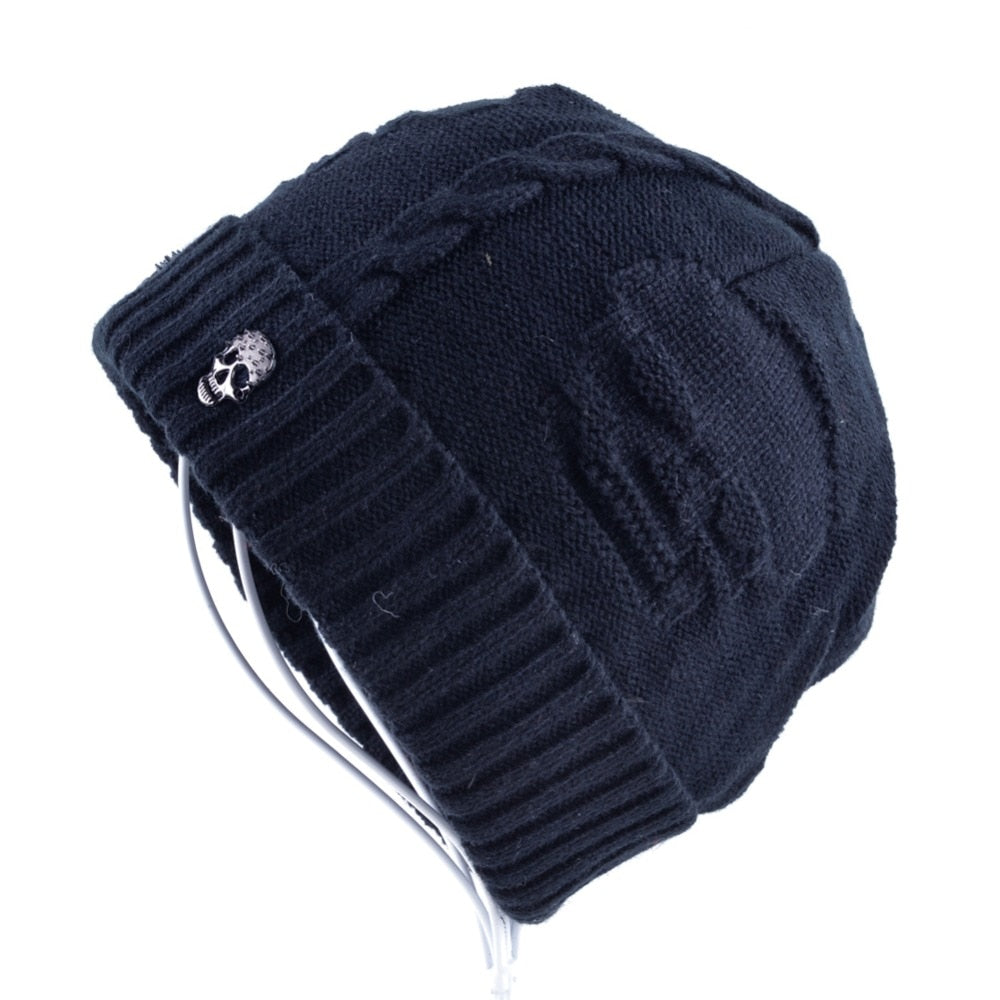 Knitted wool beanie with skull pattern and iron skull decor, perfect for alternative winter fashion.
